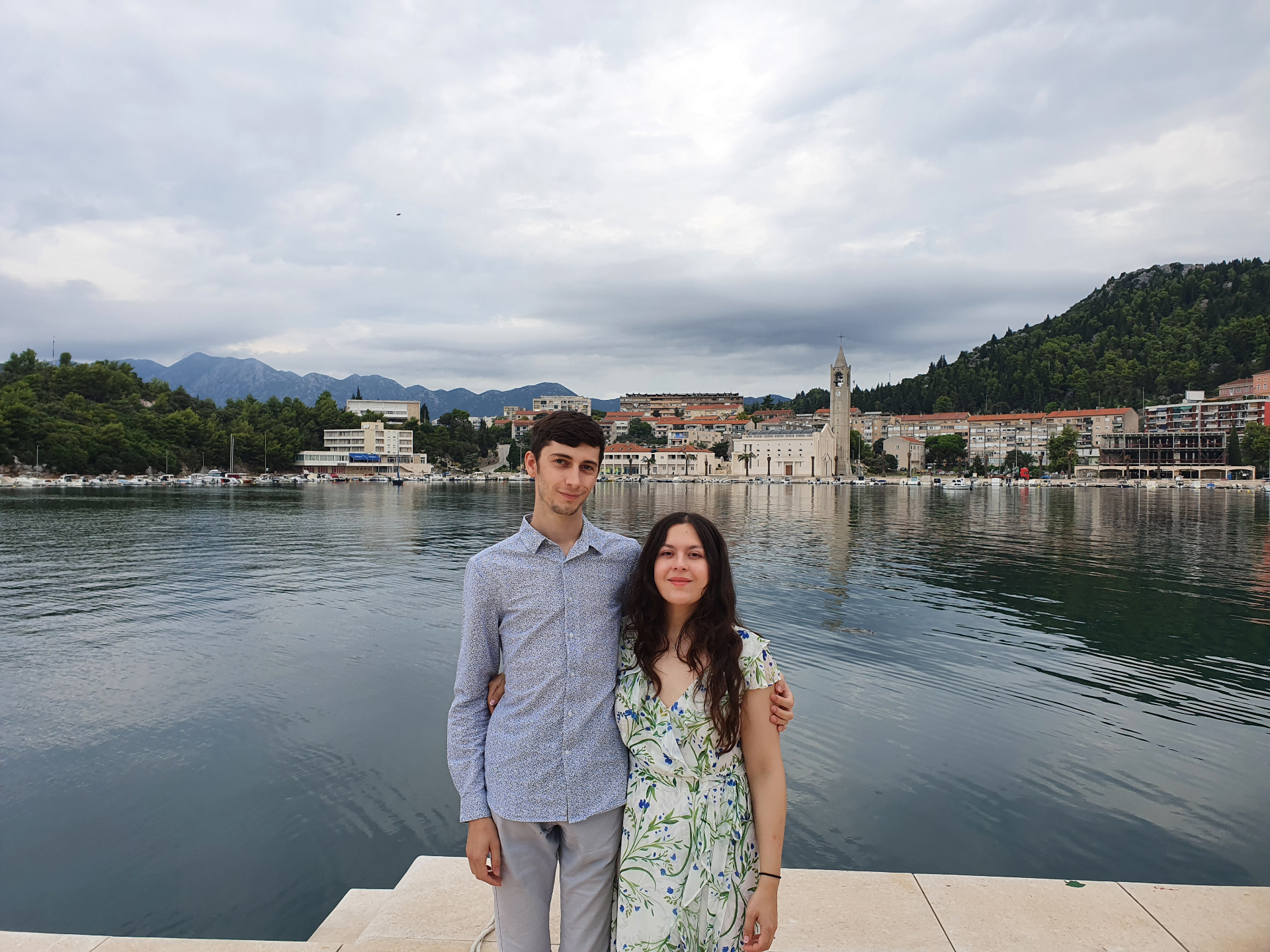 Sarah and Sam, founders of Keepsake Family History, standing together by a harbour.