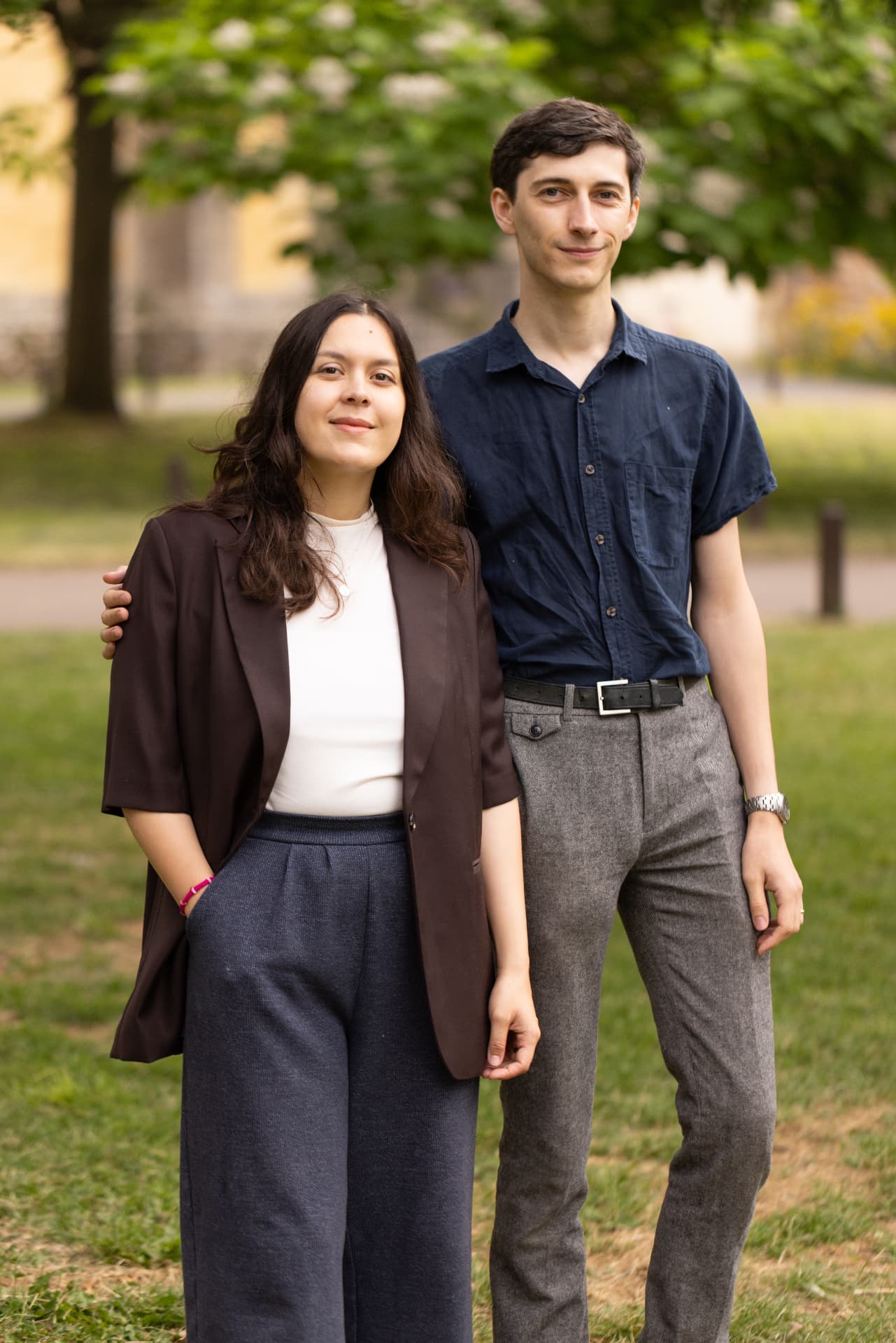 Sarah and Sam, founders of Keepsake Family History, standing together by a harbour.